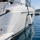 Illustration of a white yacht hull with water droplets and a clean fender at a marina